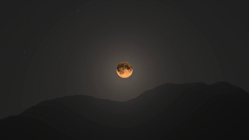 The Moon low over the ridge at night, reddened by the air